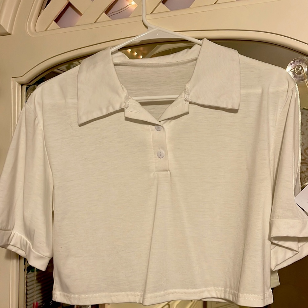 Collared white shirt that goes great with high jeans, or under a crew neck!